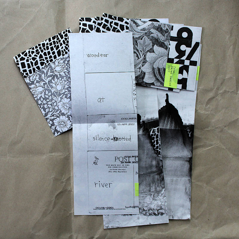 Printed copies of a four-postcard-poem by Jared Demick. Some covers show a defective runny laser print.