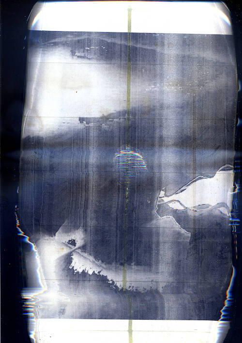 scan image. wavy video art still. printed as black and white laser label sheet. theres a big water drop in the middle of the page, the edges are distorted