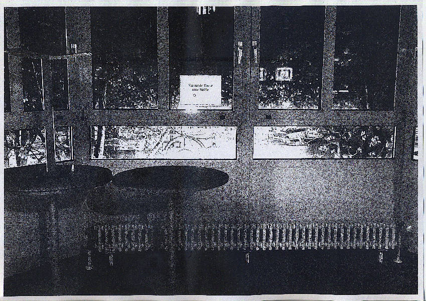 only round tables are placed next to a sign taped to the window in the bay window that reads “Only round tables without chairs”. Outside it is already night. Black laser printed copy.