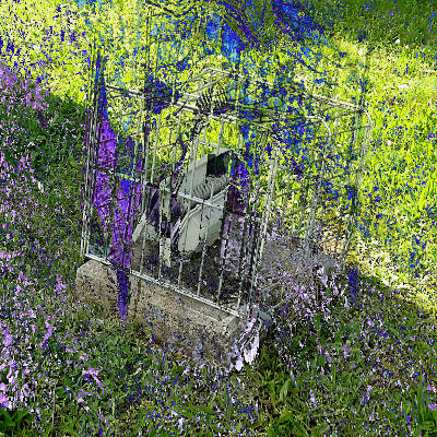 an outdor spotlight in a metal cage on green grass. the image is bright and sunny but glitched.